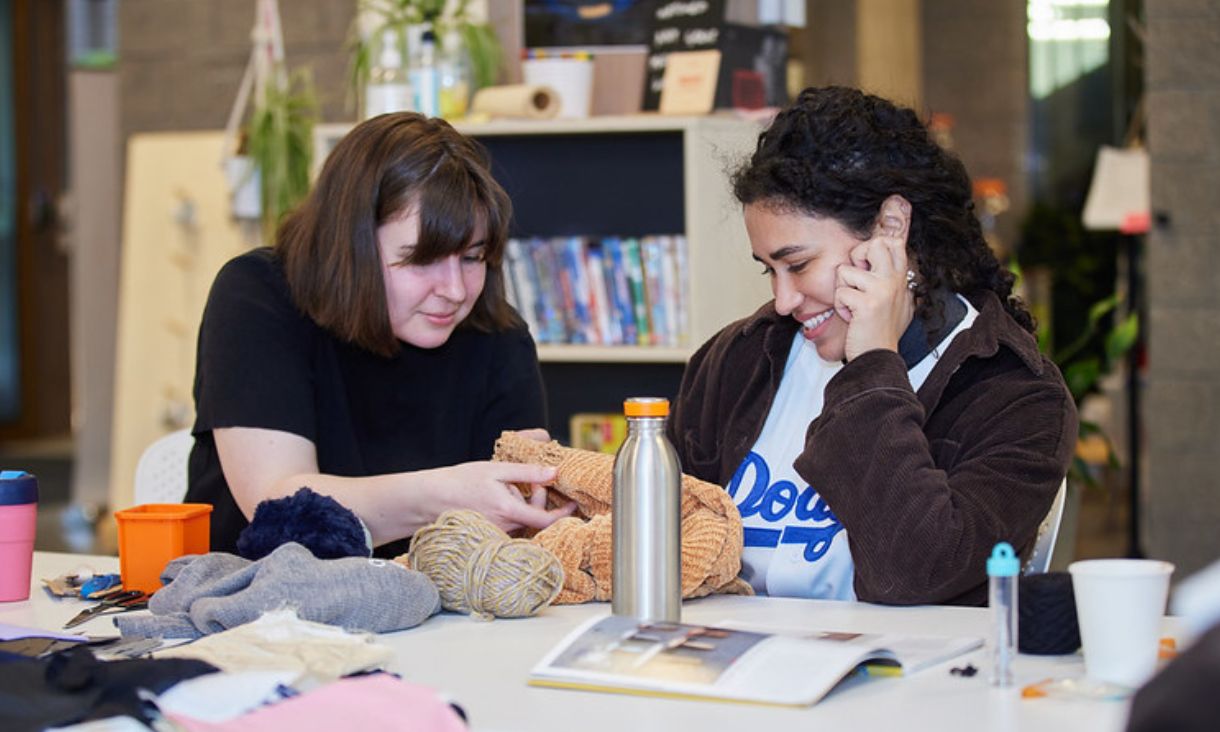 Two students working together to repair clothing