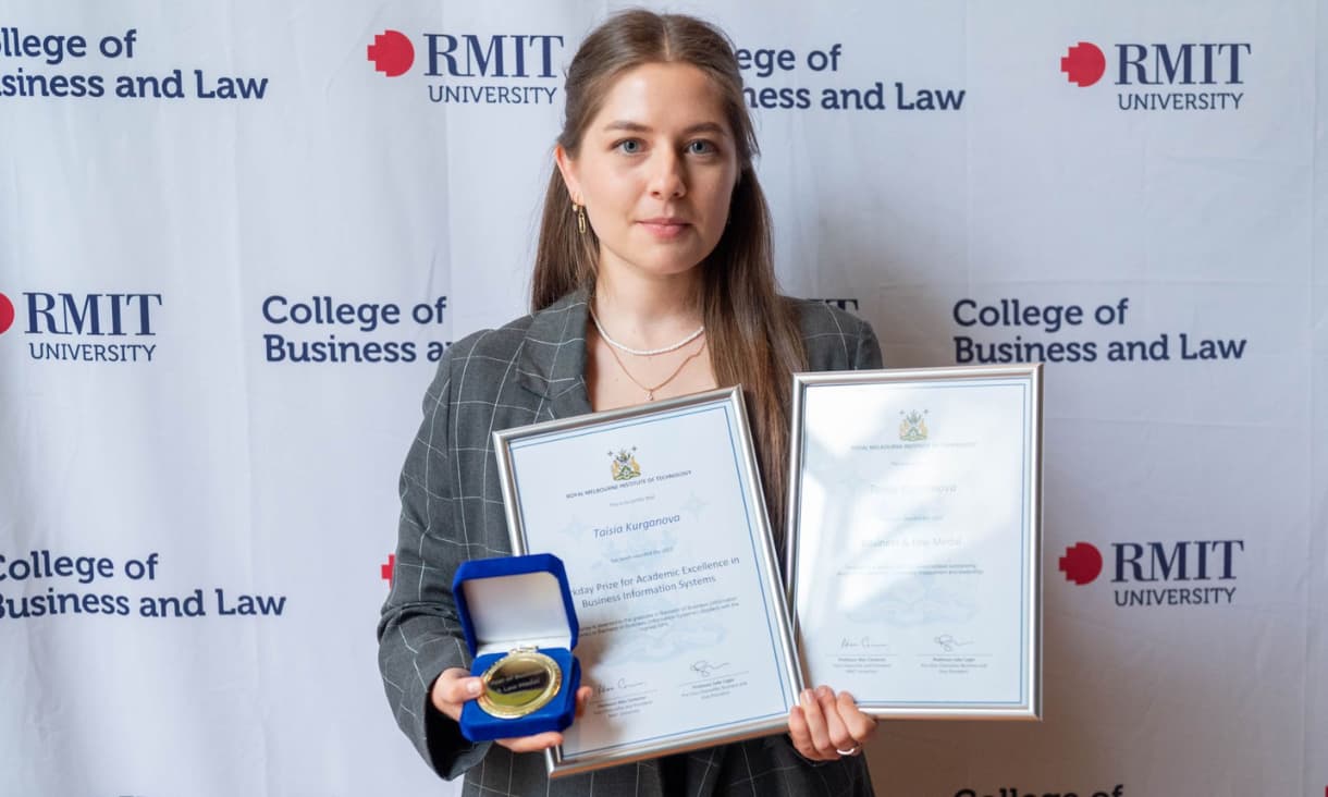 Smiling students with awards.