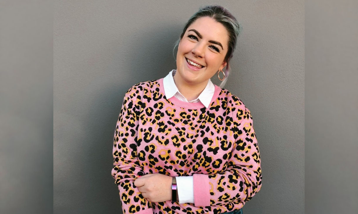 Person posing for photo with arms folded.