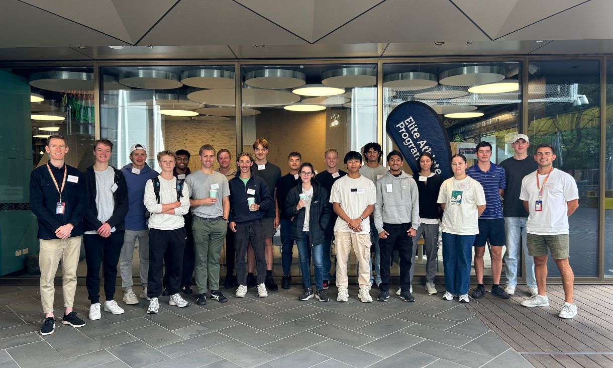 Large group of RMIT students coming together during networking event for elite and emerging athletes.