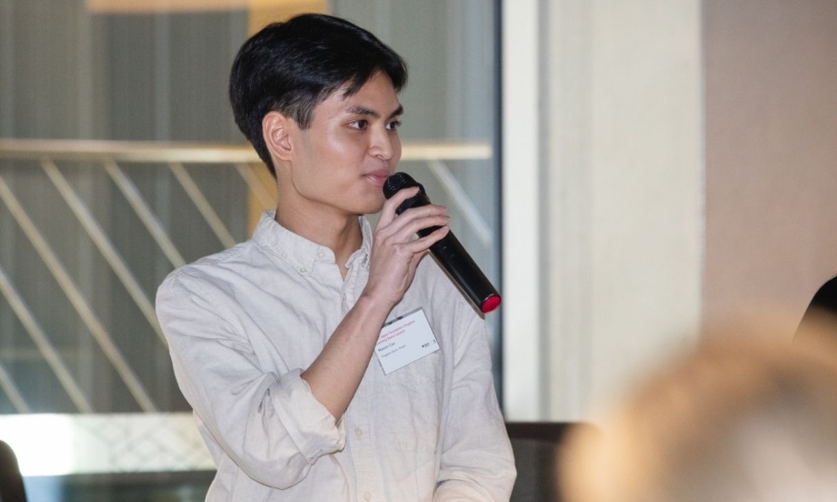 Mason Cao speaking into microphone