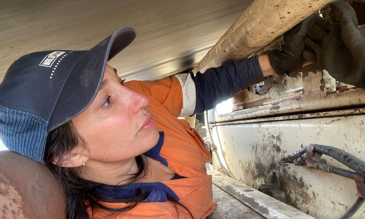 Person working underneath car