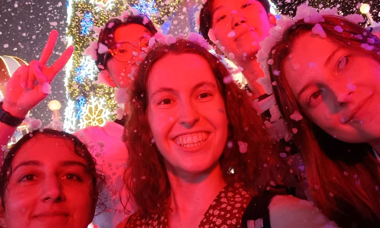 Three people pose for photo.