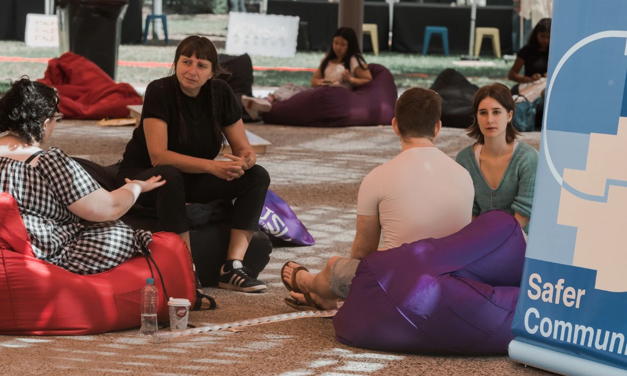Students sitting on bean bags at Safer Community event