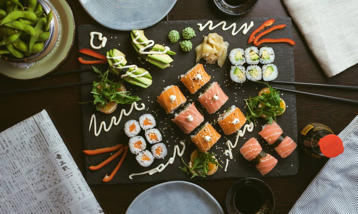 Plate of Japanese sushi and edamame on a wooden table 