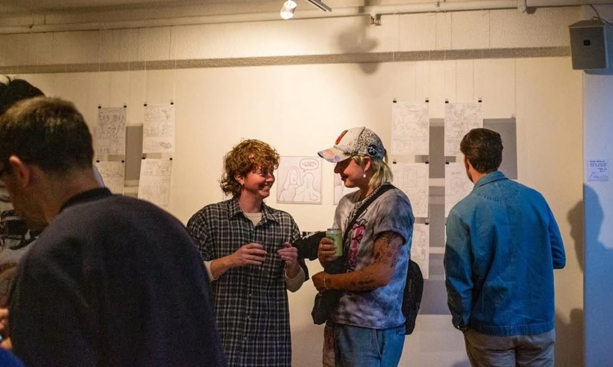 Two people at a magazine launch talking