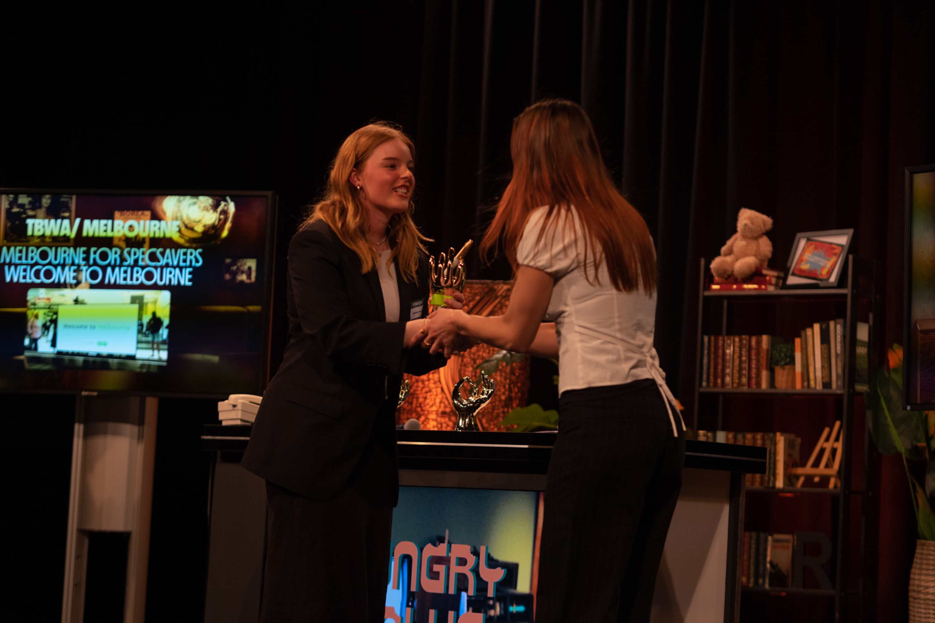 Advertising student, Charlotte Vanden Hil presents the students' choice award to TBWA for Specsavers: Welcome to Melbourne.