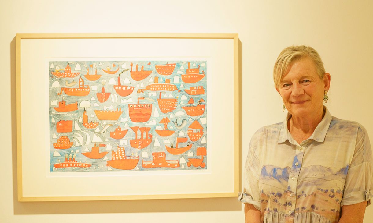 Alison Lester standing in front of illustration