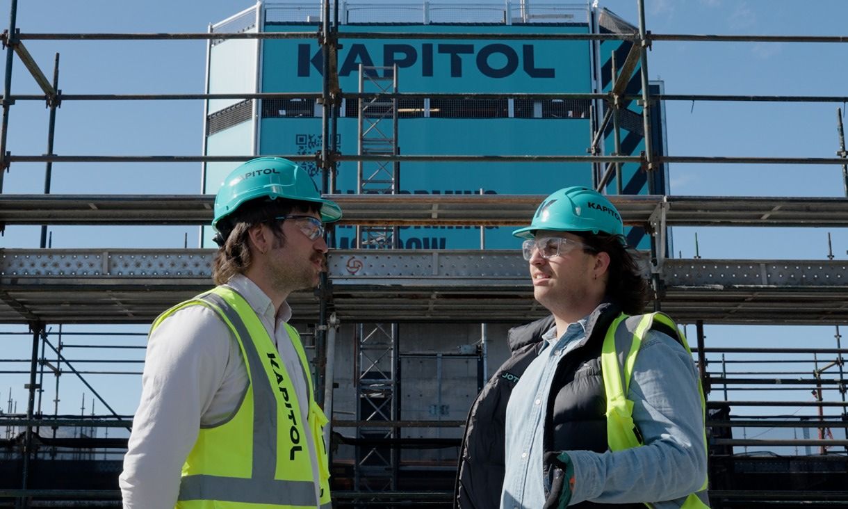Sam talking with builder at construction site