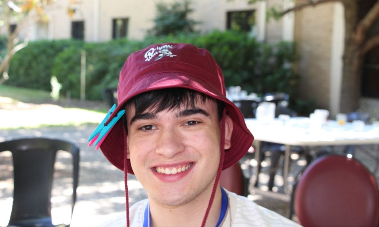 Person wearing bucket hat standing outside