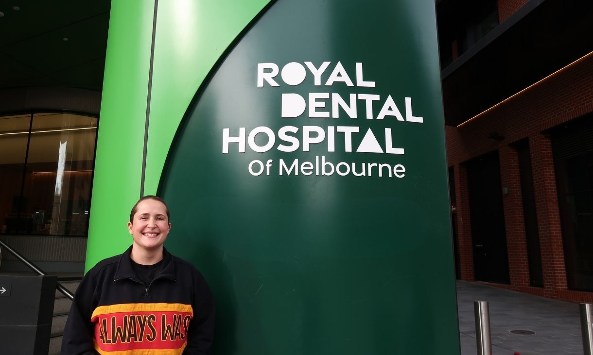 Person standing in front of Royal Dental Hospital pillar