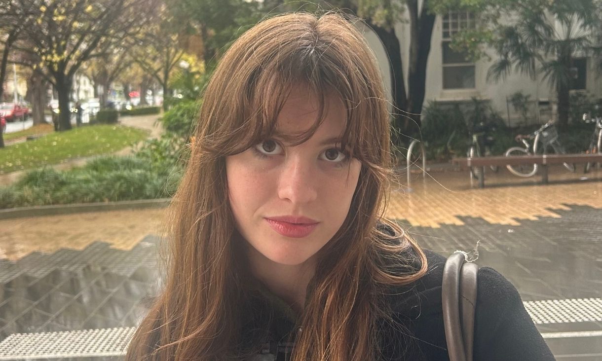 Girl looking at camera standing outside