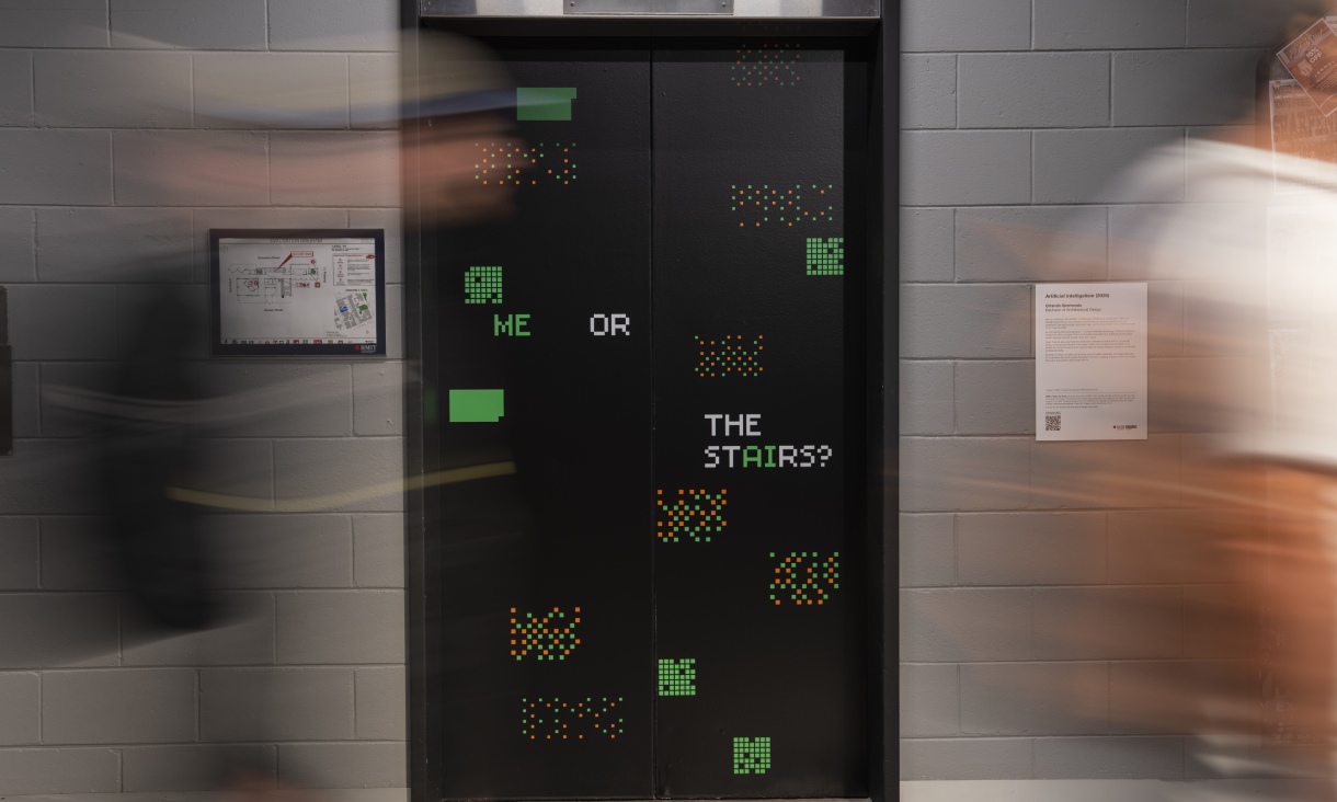 Lift doors in Building 10 at RMIT displaying the text “ME OR THE STAIRS?” with pixel-style graphics, with blurred figures passing in front.