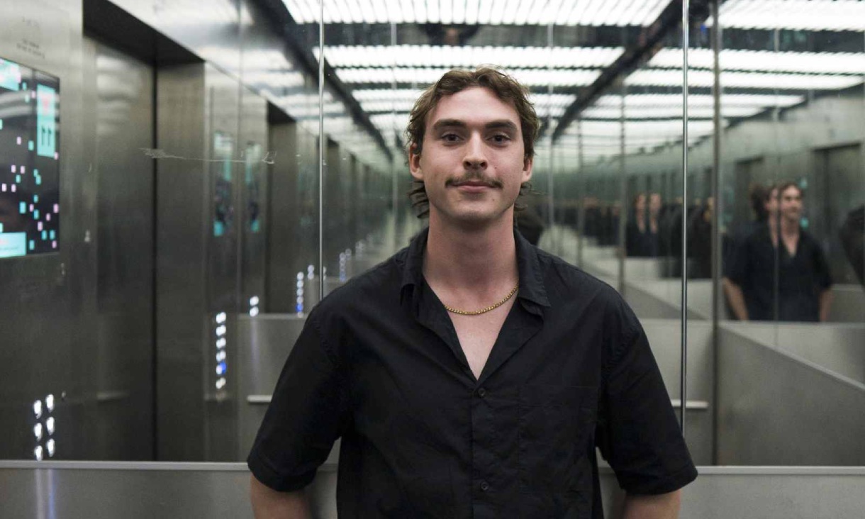 Student artist Orlando Simmonds inside a Building 10 lift at RMIT, where his artwork Artificial Intelligelism is installed.