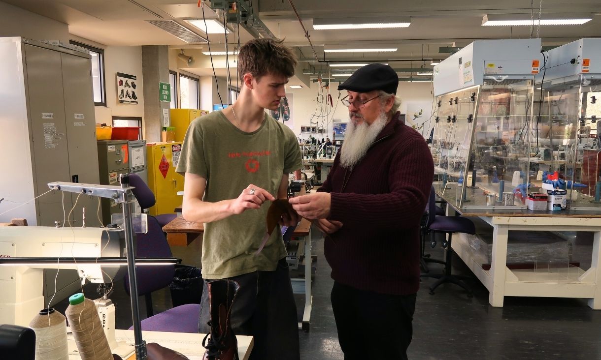 Shoemaker helping a student