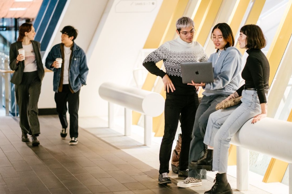 Students looking at laptop