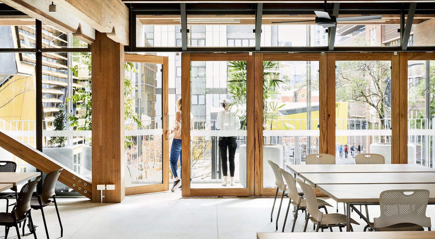 A common area with chairs and tables at the City Campus.