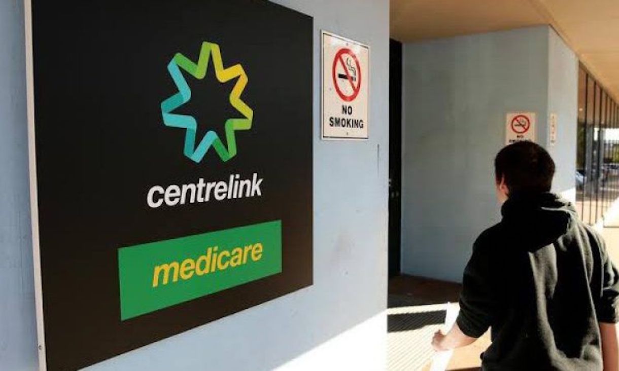 Person entering Centrelink Medicare building.