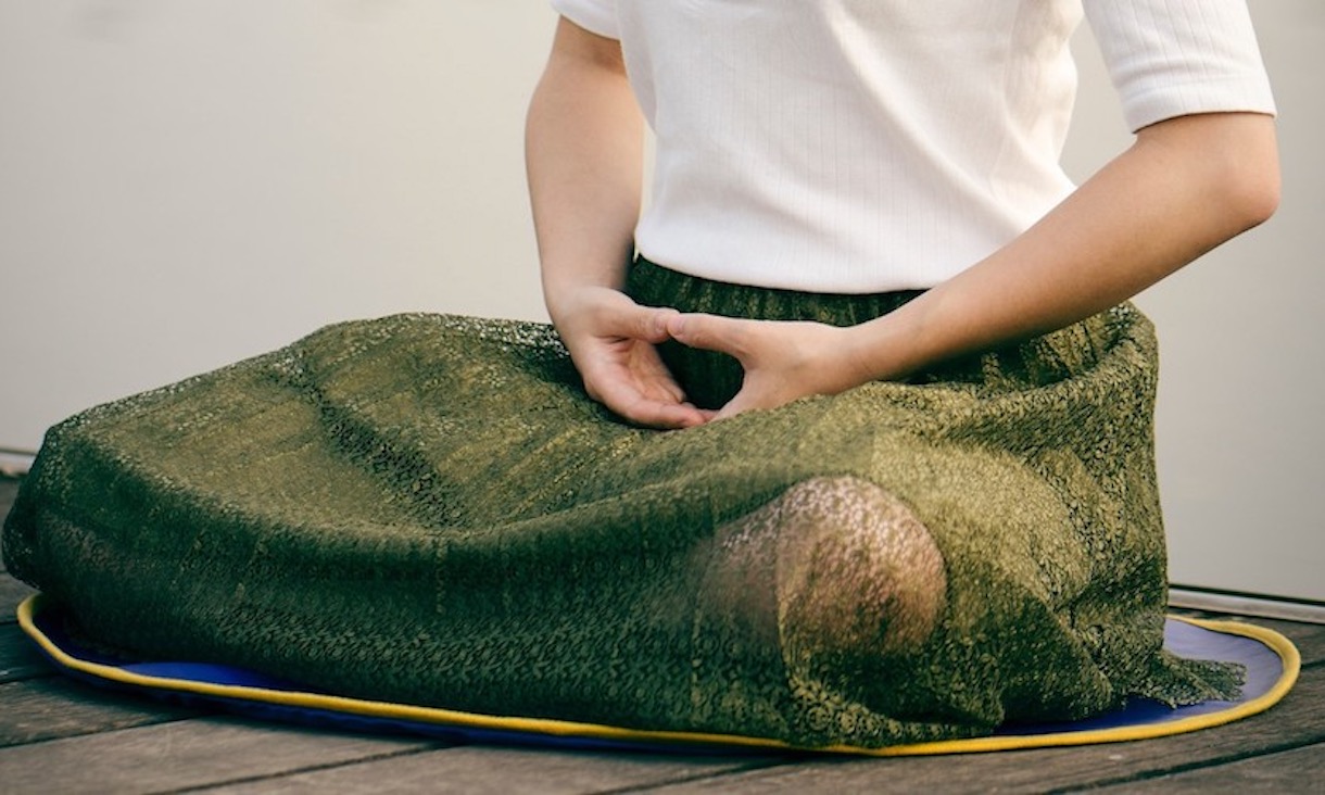 A person sitting cross-legged.