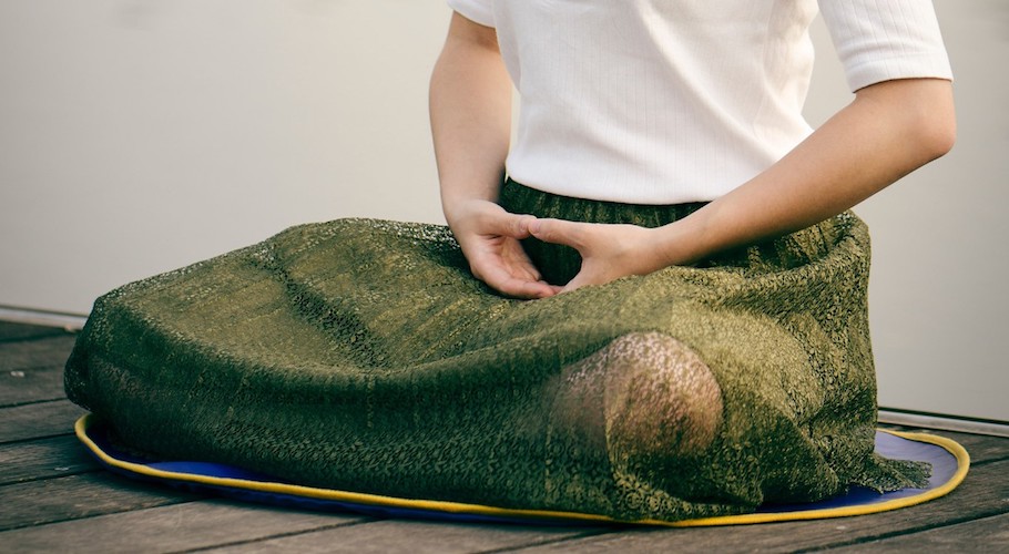 A person sitting cross-legged.