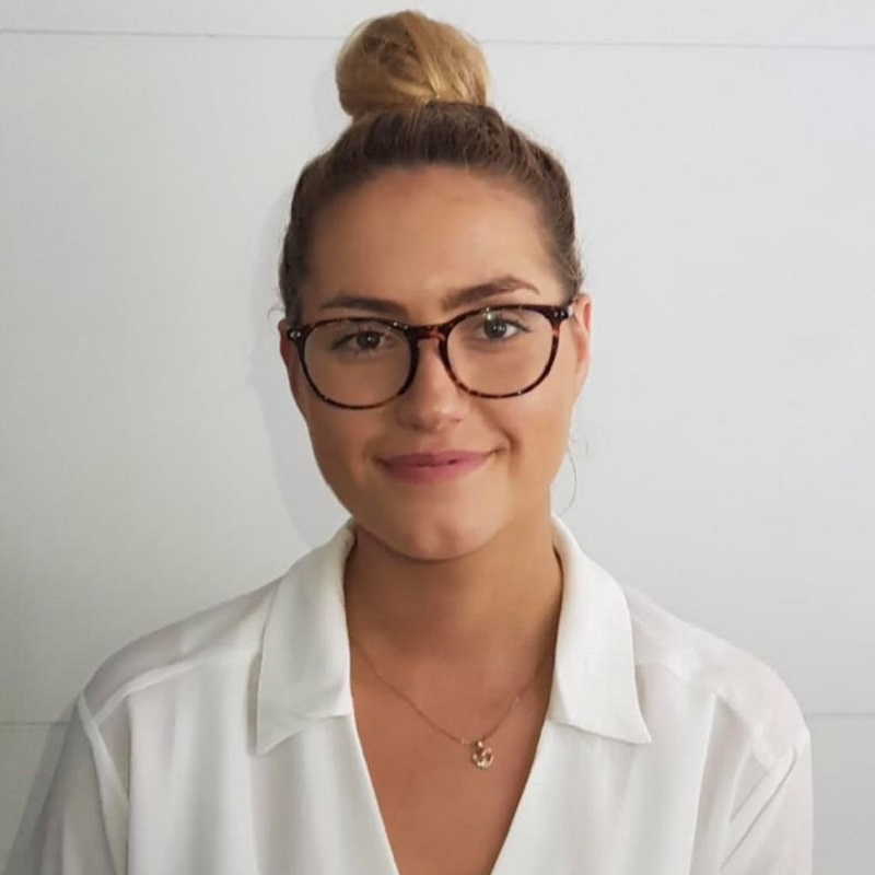 Elle smiles wearing glasses