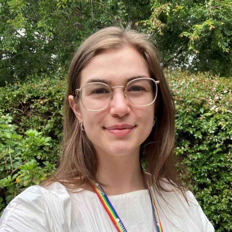 Ruth wears glasses and smiles outside