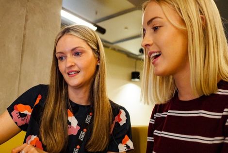 An RMIT staff member assists a student.