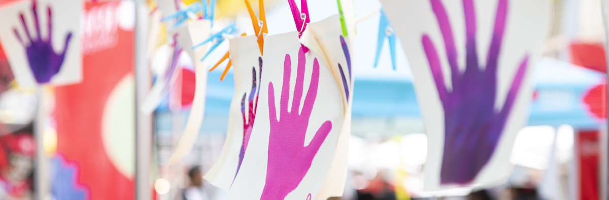 Colourful traced hands hang in a classroom.