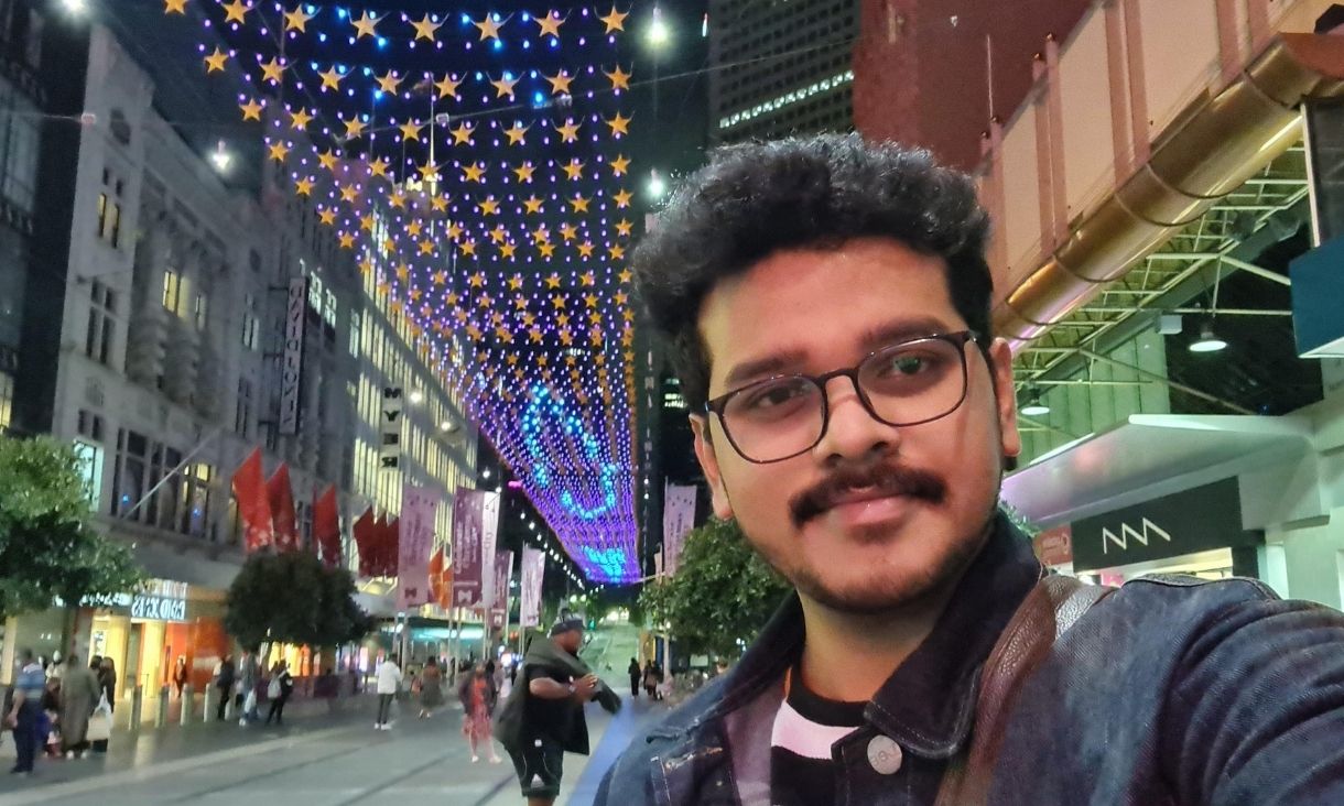 Calvin stands in Bourke Street Mall, Melbourne.