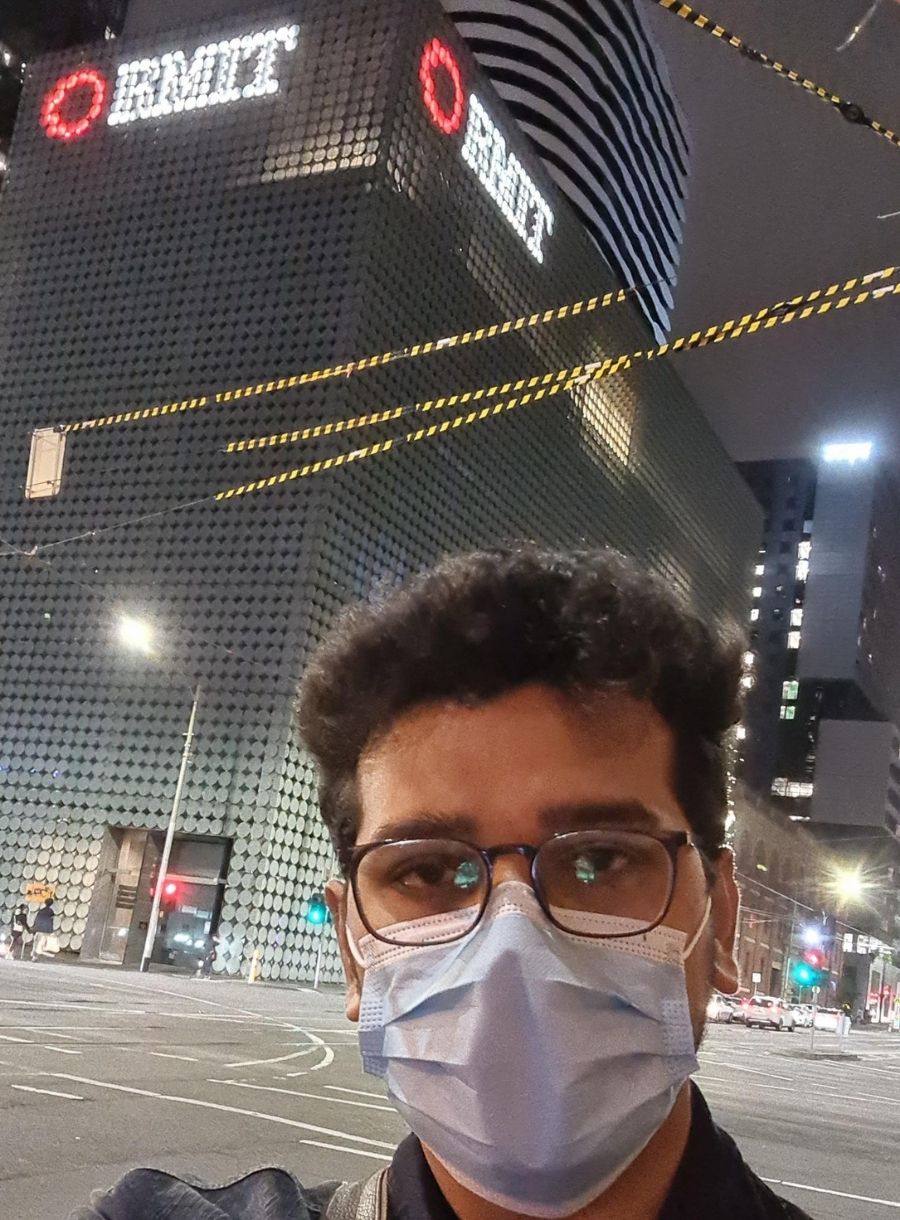 Calvin takes a selfie in front of an RMIT building.