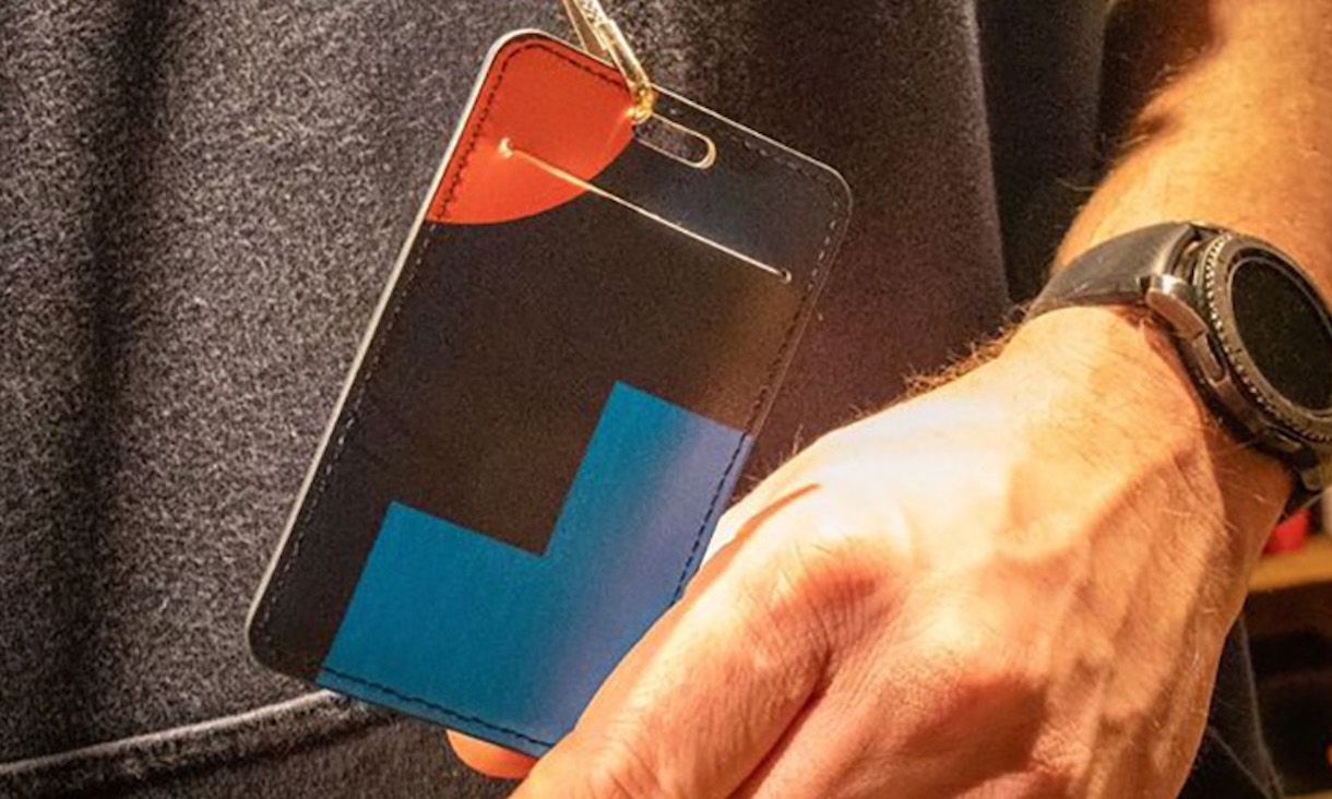 Hand holding an RMIT student card lanyard