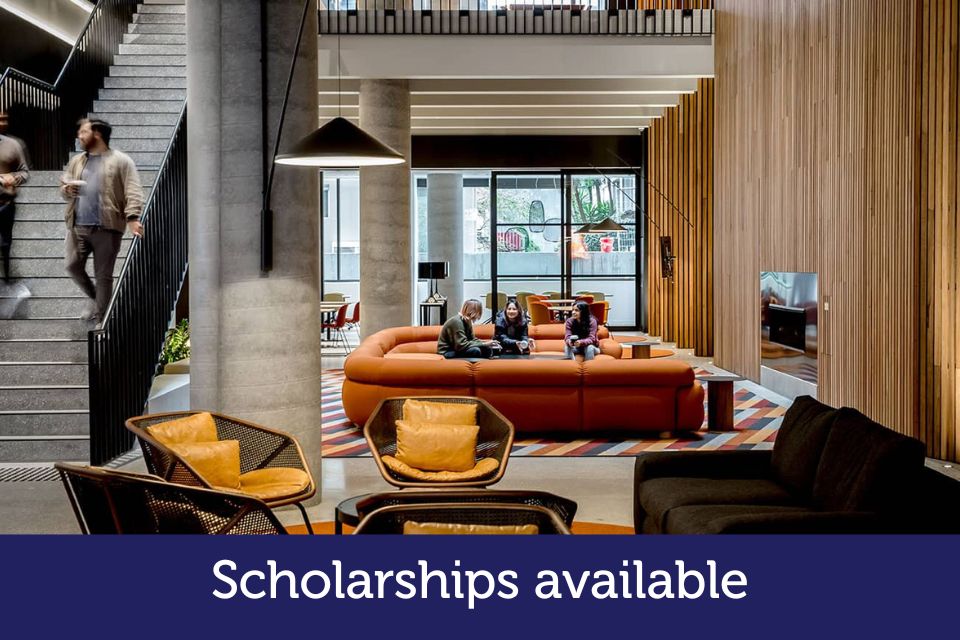 A modern lobby with couches is featured. The words 'Scholarships available' are printed on the photo.