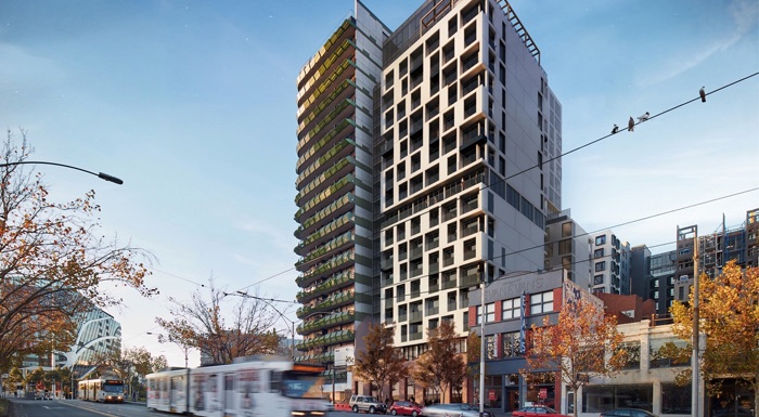 A skyscraper with a tram driving by.