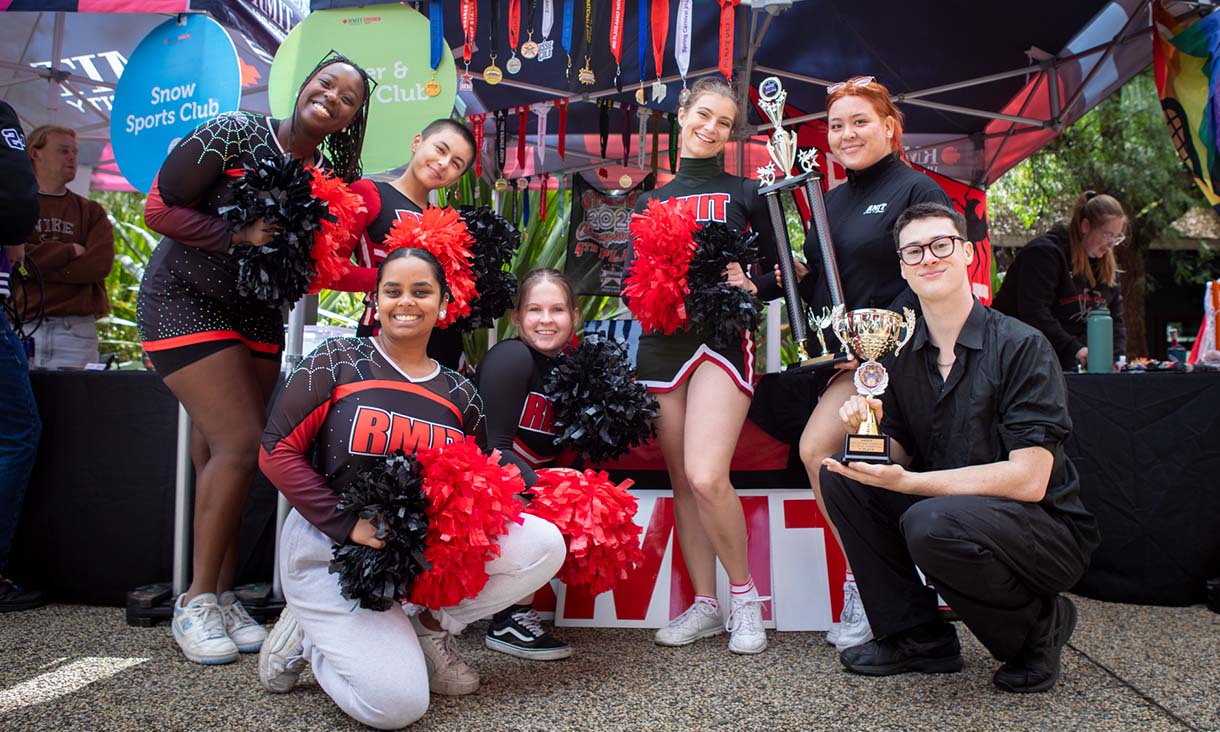 Cheerleader club posing with trophy