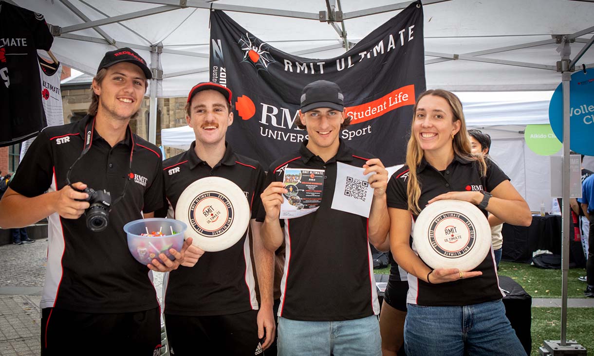 Frisbee club holding up frisbees.