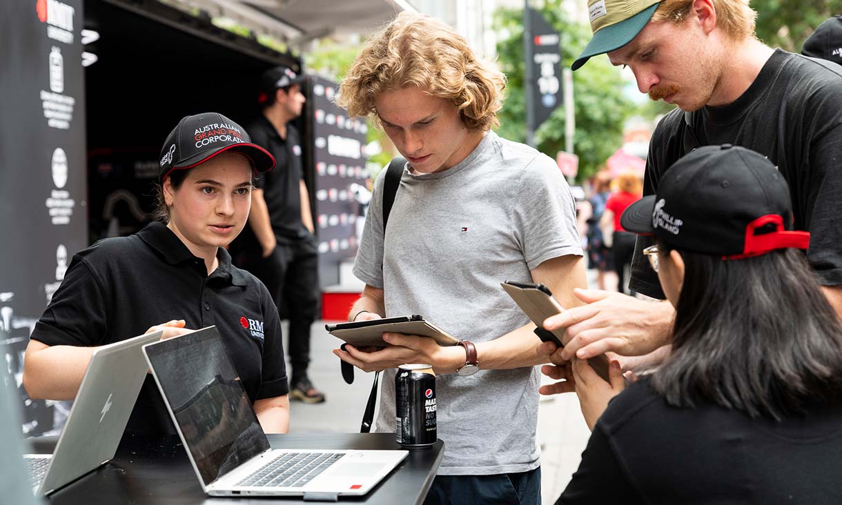 People paying on an iPad at a stall.