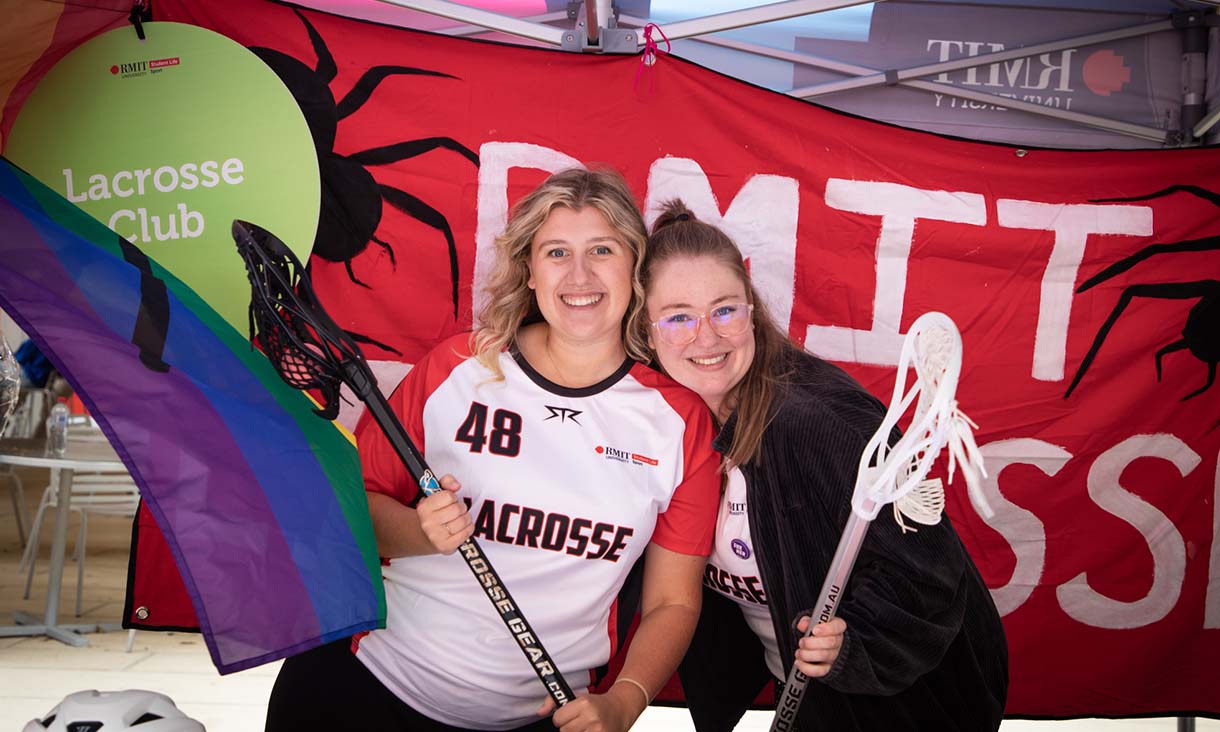 Two members of the lacrosse club smiling