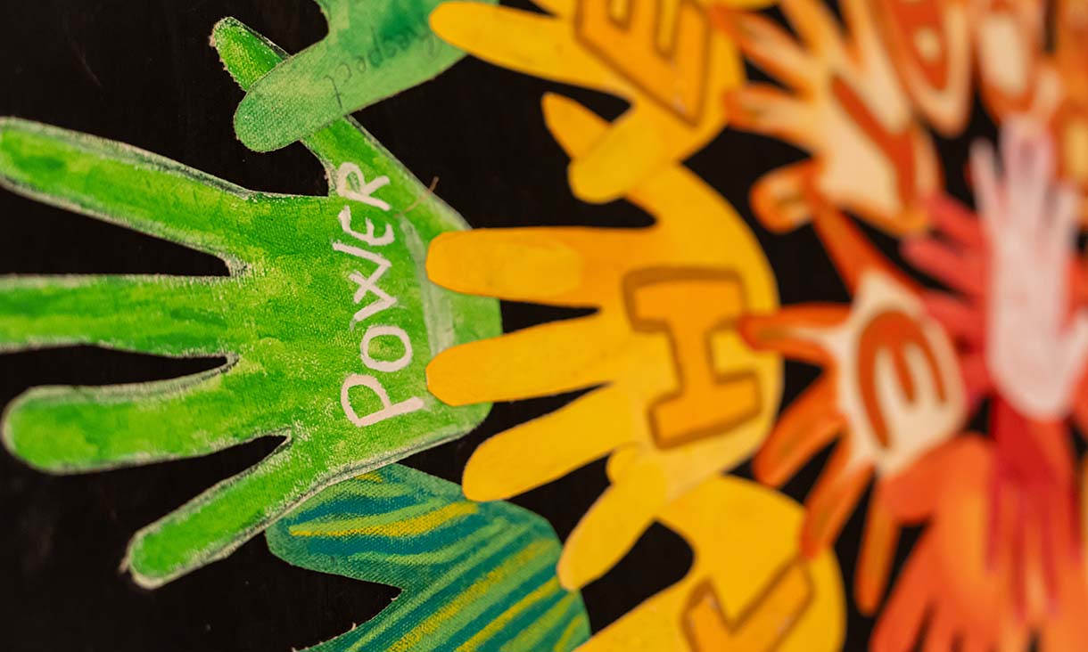 Artist Jo Mott shapes the hands into a large design.