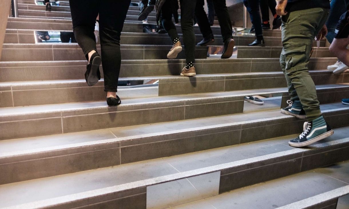 People walking up concrete stairs