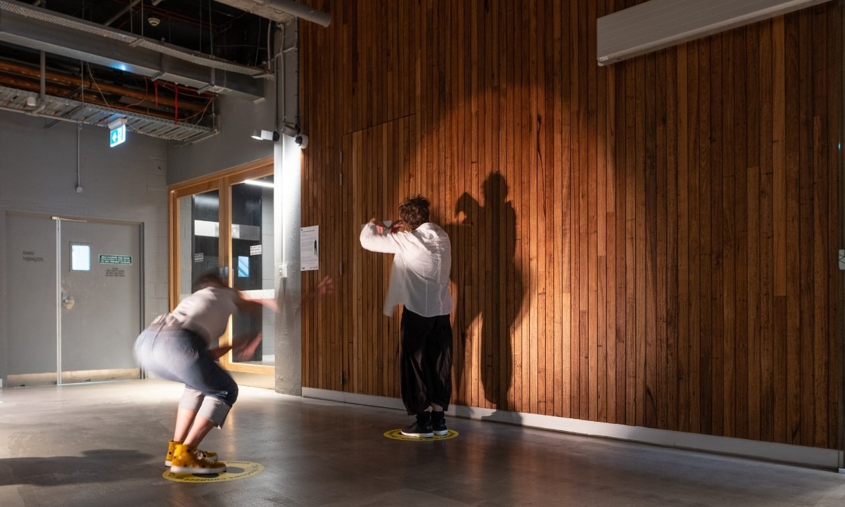 Two people taking photos of shadows