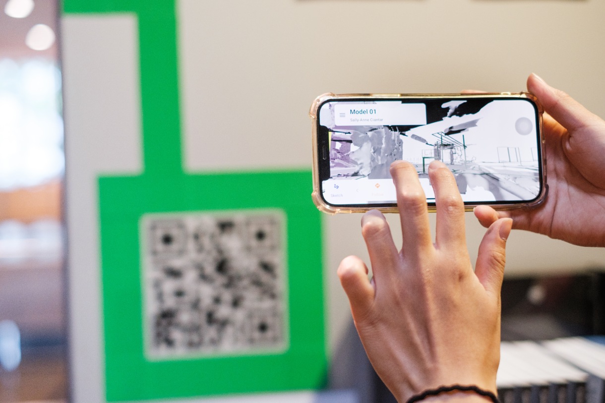 Person scanning QR code with phone