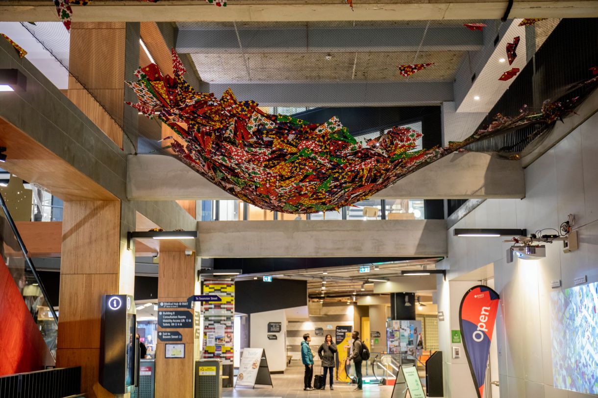 Pile of paper planes held in net
