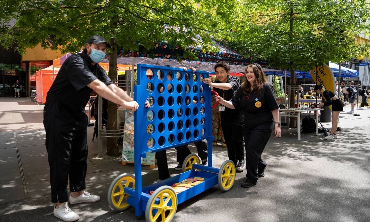 People moving large connect 4 