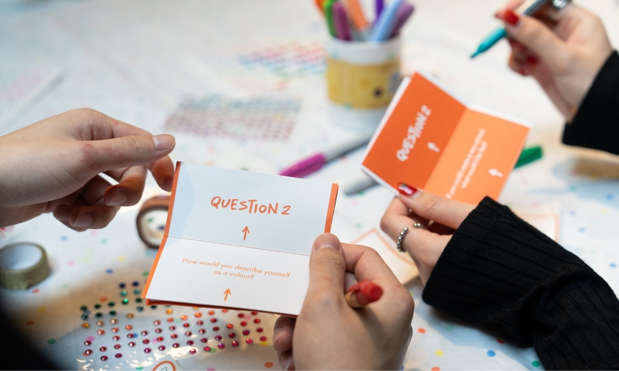 Two people writing on card