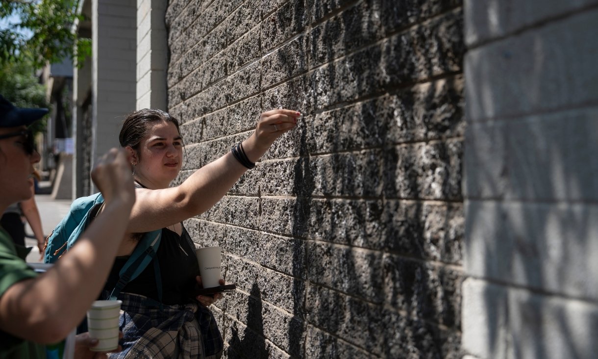Person drawing on brick wall