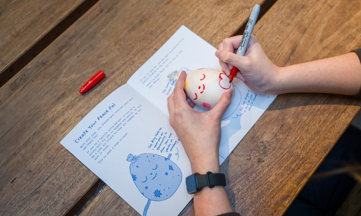 Person drawing on egg