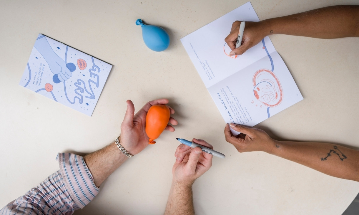 People drawing on balloons