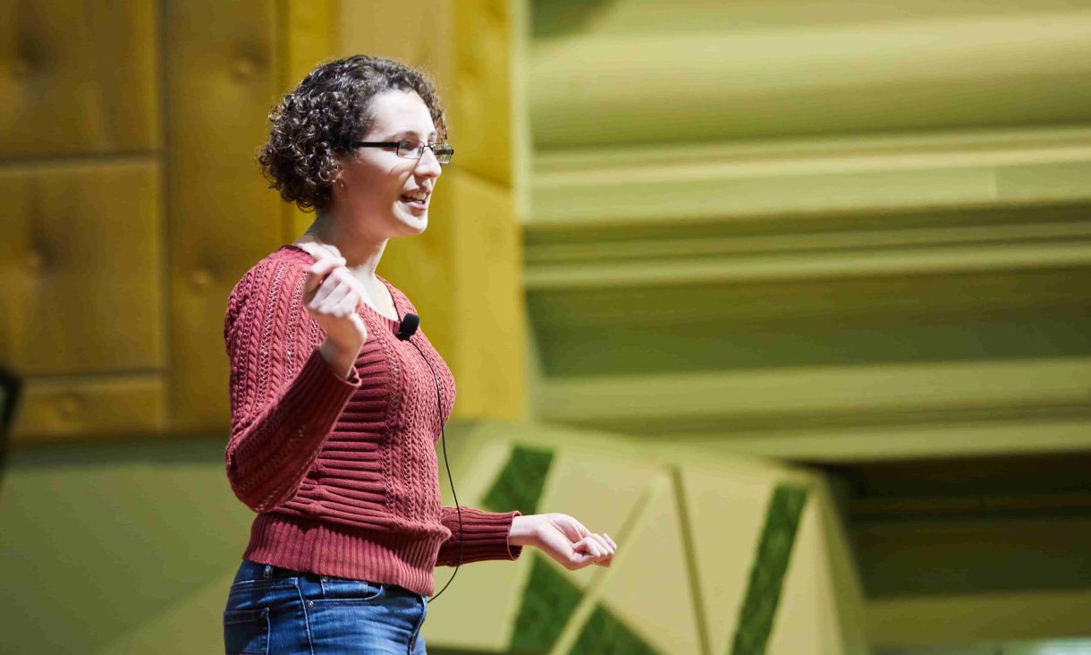 Woman wearing a lapel microphone talking.