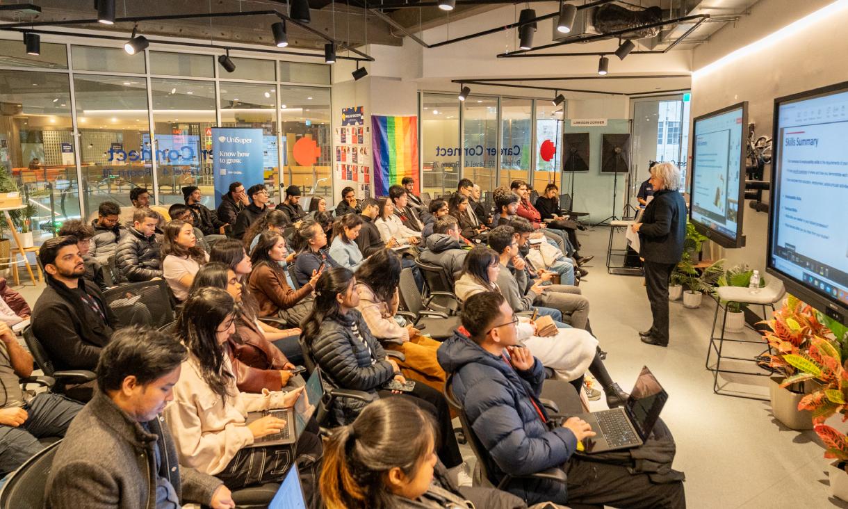 Person presenting to group of people