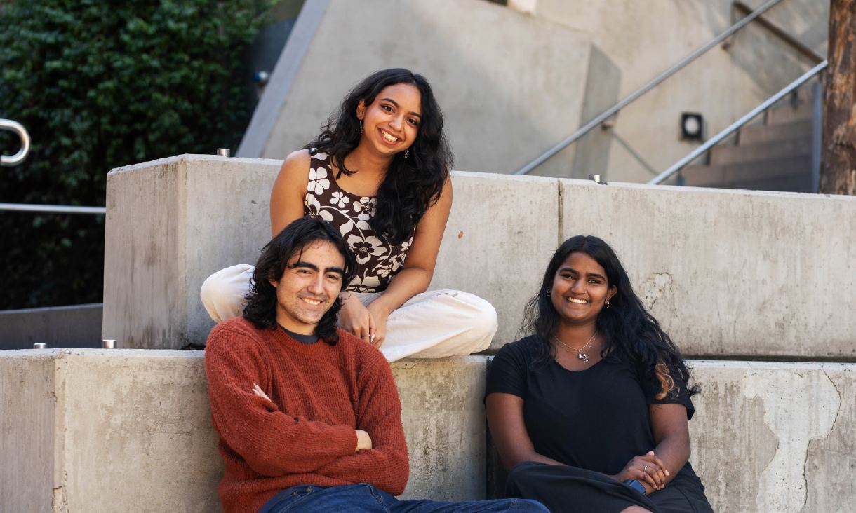 Three friends sitting on concrete steps